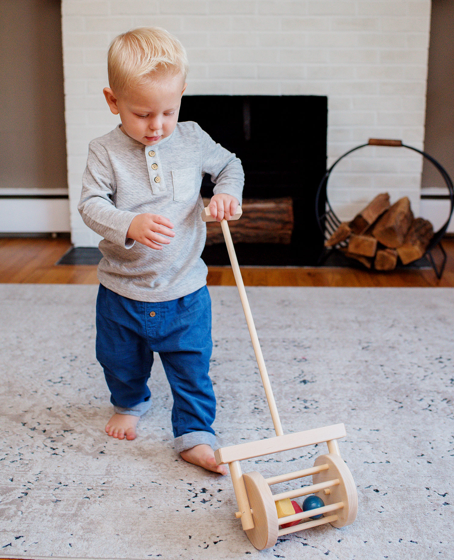Young boy pushing block roller toy